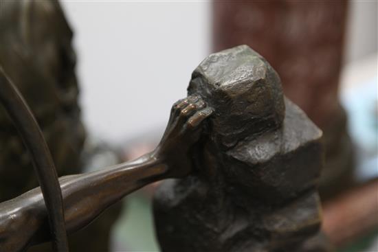 A bronze figure of a nude archer standing upon a rocky outcrop, 22in.